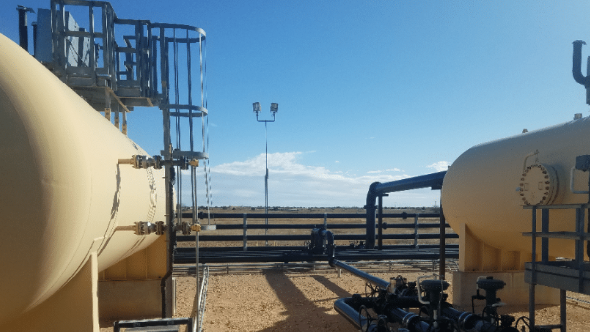 Industrial CO₂ pipeline facility showing tanks, valves and pipelines in open field